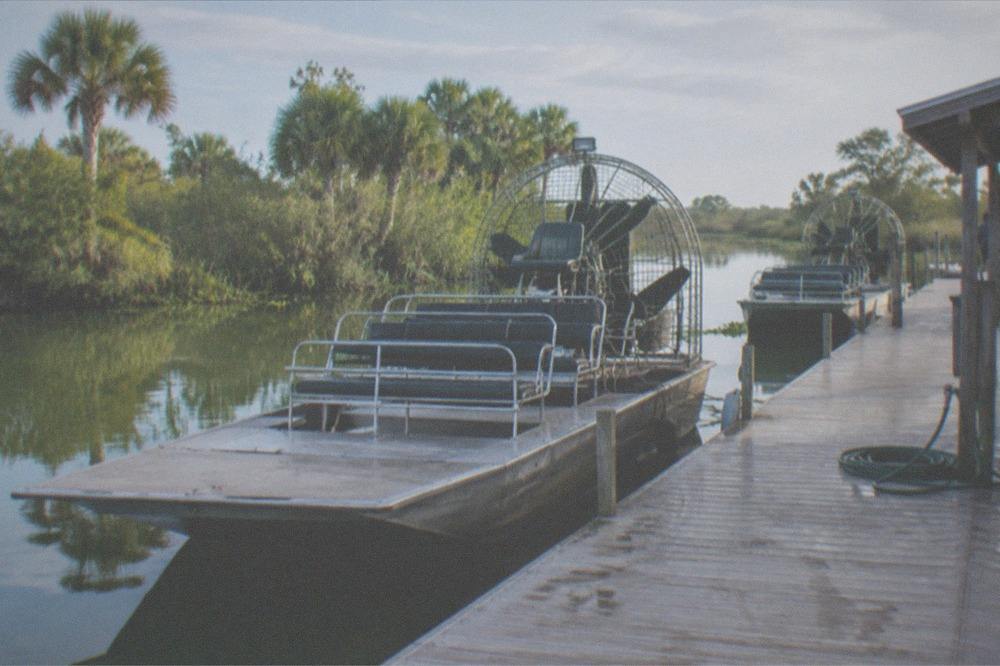 Airboat dock and calm morning water at a Kissimmee launch site