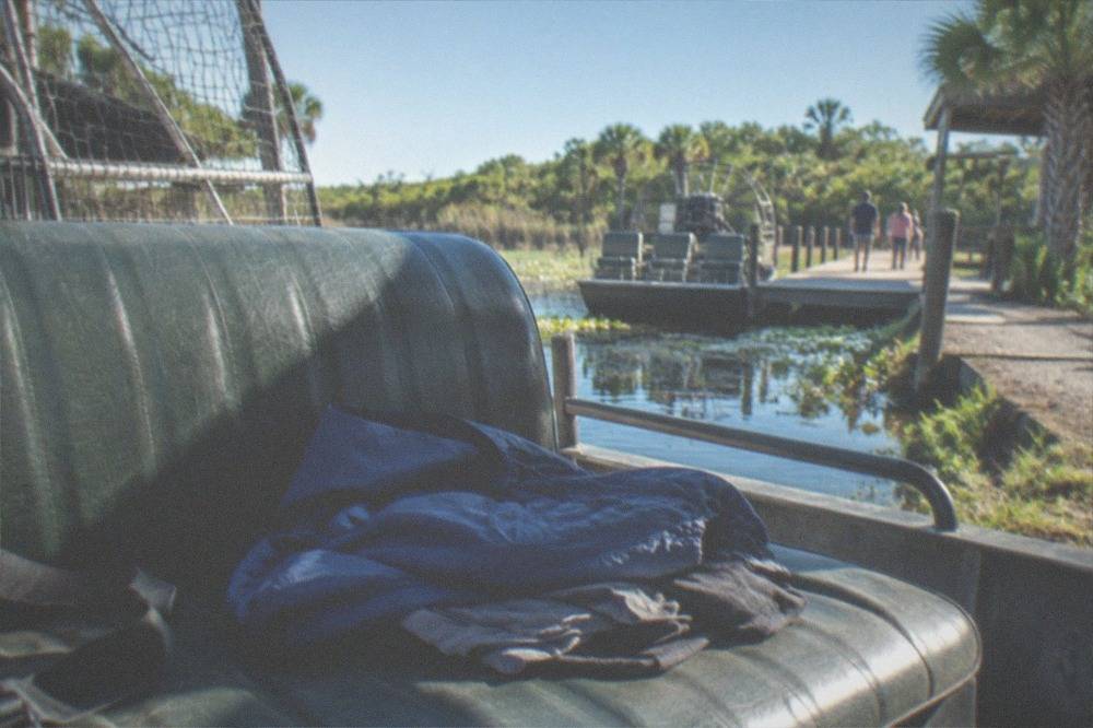 Windbreaker and quick-dry clothing laid out on a boat bench seat