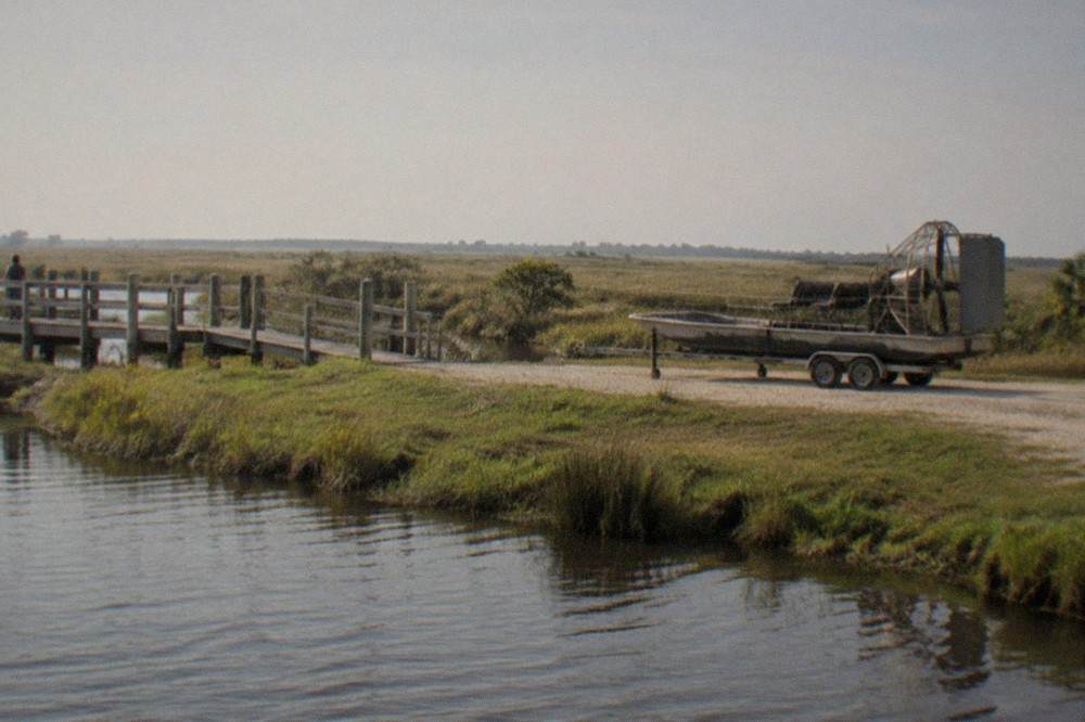 An airboat dock at a Central Florida marsh landing with flat grassland stretching to the horizon