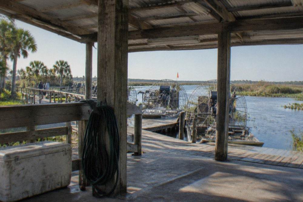 A covered airboat dock at a Central Florida marsh launch point on a bright morning